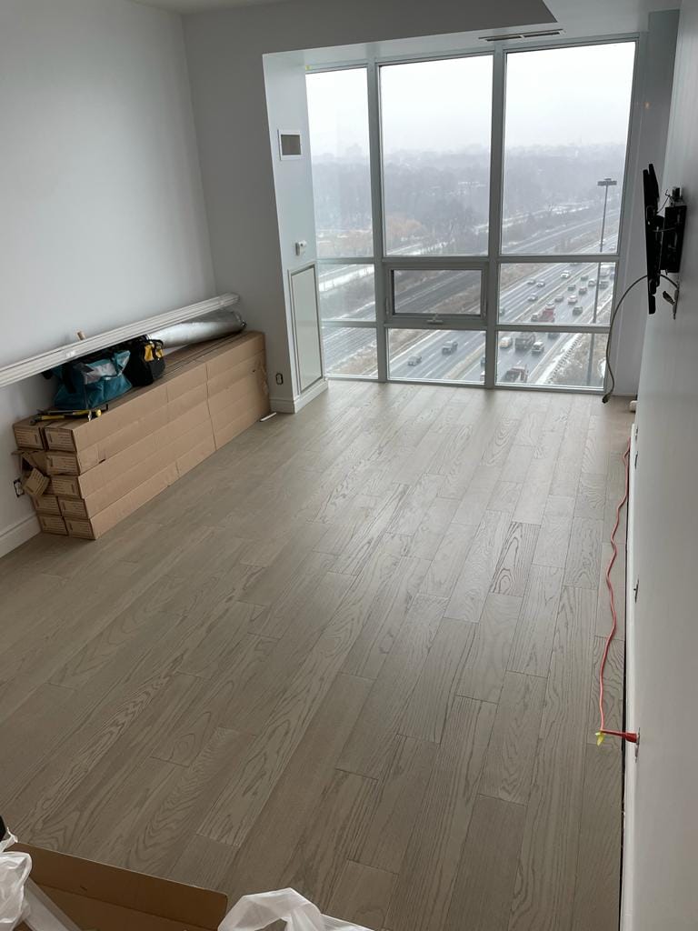Condo living room with light grey vinyl plank flooring